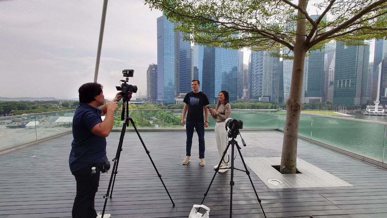An image of Gregory Hemmer being interviewed by a journalist at Token 2049 in Singapore